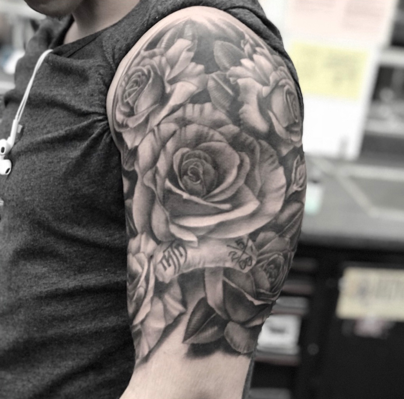 Black and grey rose tattoo on the left forearm
