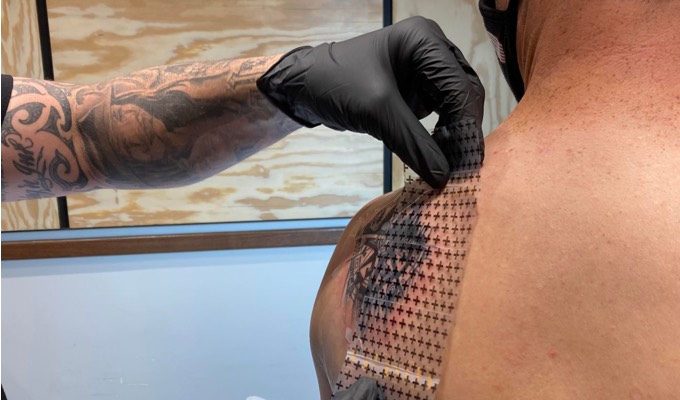 Applying a protective covering over a tattoo